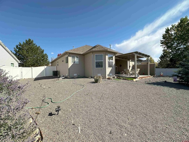 rear view of property with a patio, central AC, and a pergola