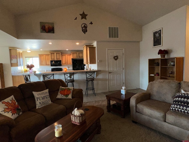 living room featuring high vaulted ceiling