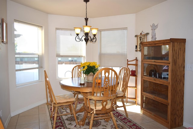 tiled dining room with a notable chandelier