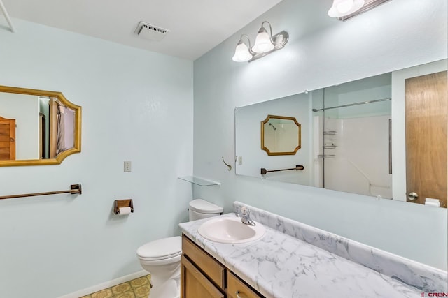 bathroom with a shower, vanity, and toilet