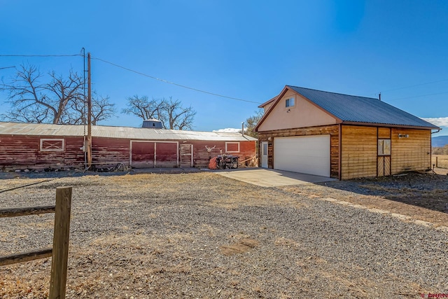 view of side of property with a garage and an outdoor structure