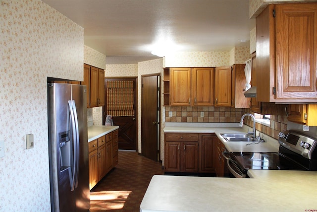 kitchen with kitchen peninsula, stainless steel appliances, and sink