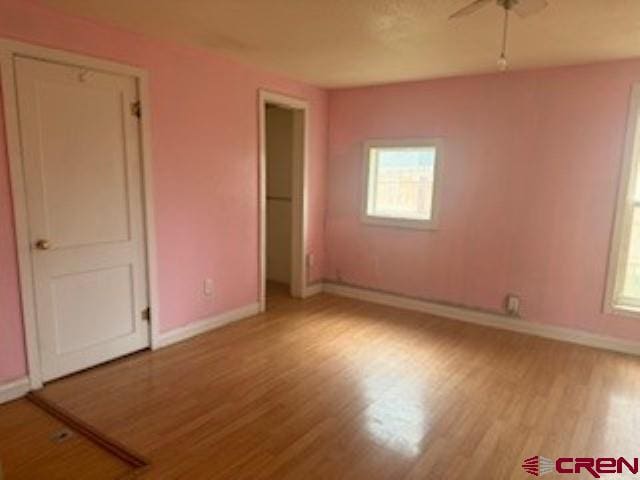 unfurnished bedroom featuring light hardwood / wood-style floors and ceiling fan