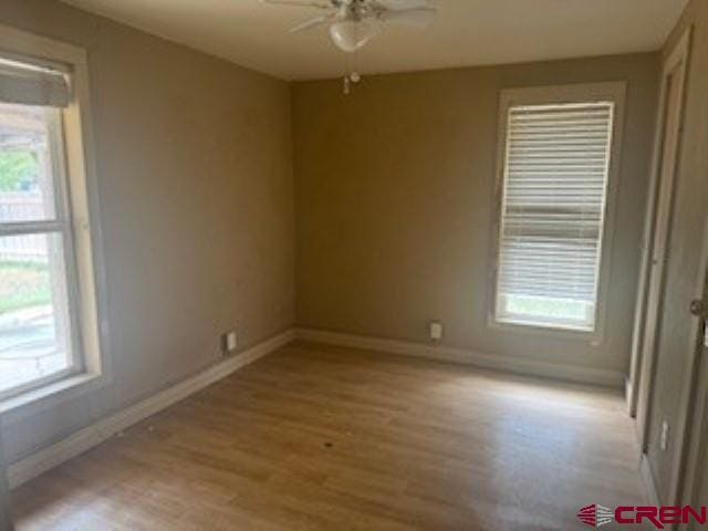 spare room featuring light hardwood / wood-style flooring and ceiling fan