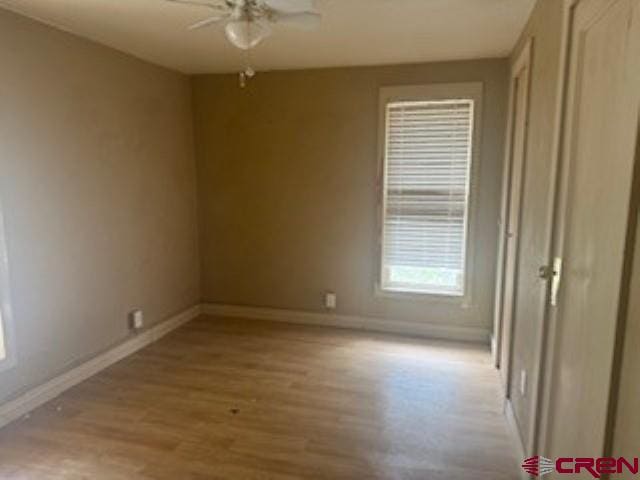 empty room featuring light wood-type flooring and ceiling fan