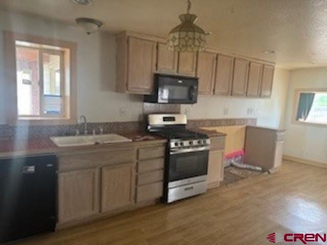 kitchen featuring light hardwood / wood-style flooring, black appliances, sink, and light brown cabinetry