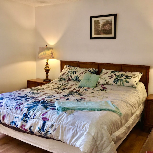 bedroom with dark wood-type flooring