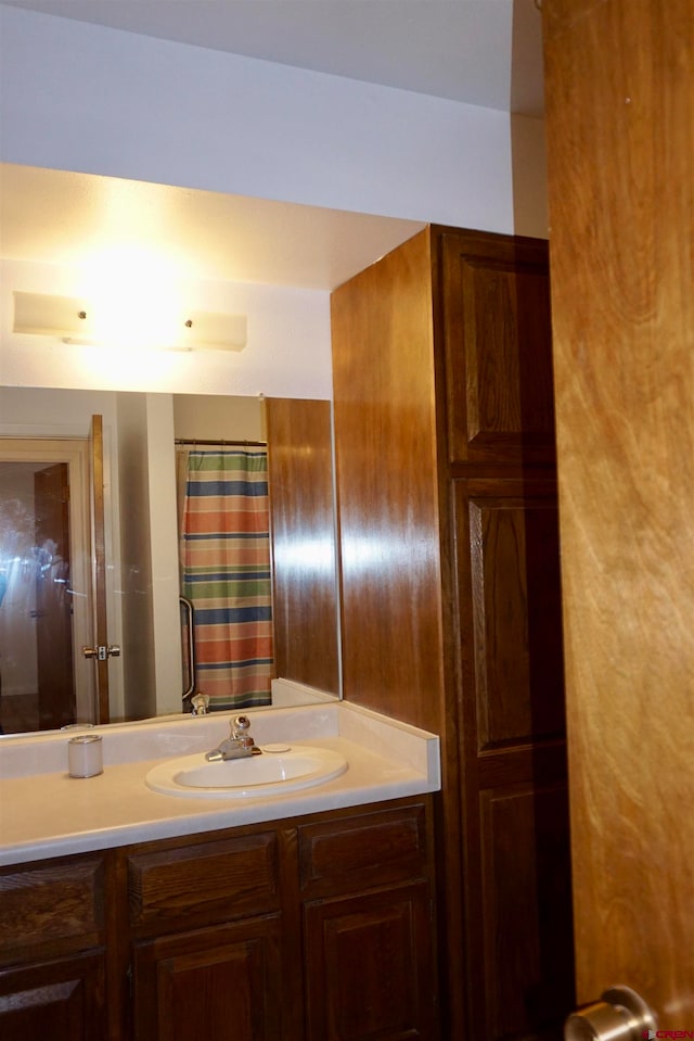 bathroom featuring vanity and a shower with shower curtain