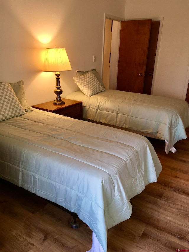 bedroom featuring dark wood-type flooring