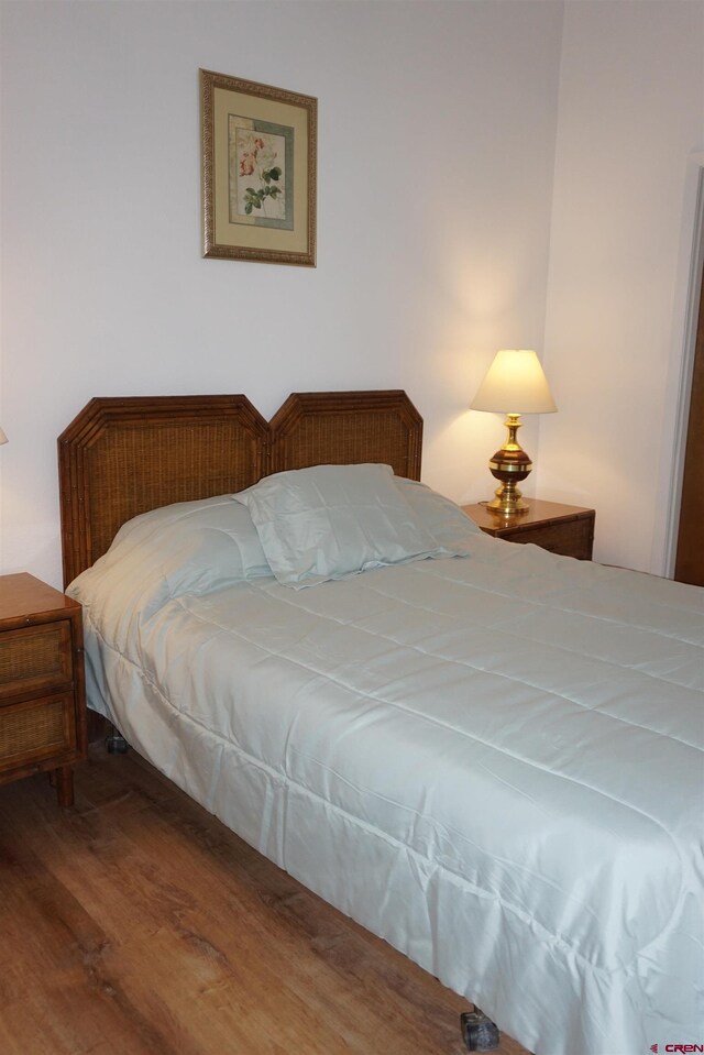 bedroom with wood-type flooring