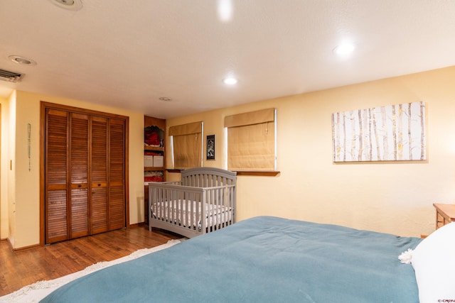 bedroom featuring a closet and dark hardwood / wood-style floors