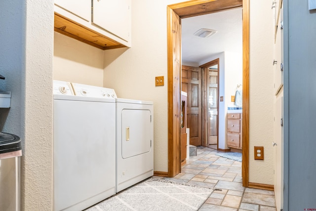 washroom with cabinets and independent washer and dryer