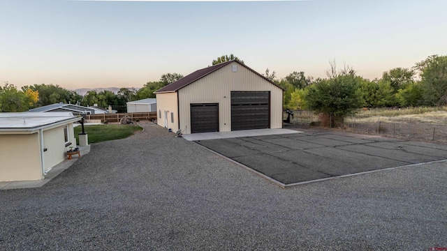 view of garage at dusk