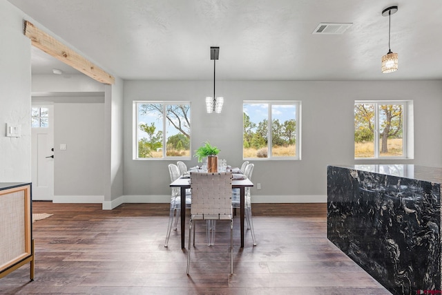 dining area with dark wood-type flooring and plenty of natural light