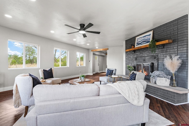 living room featuring a brick fireplace, ceiling fan, and dark hardwood / wood-style flooring