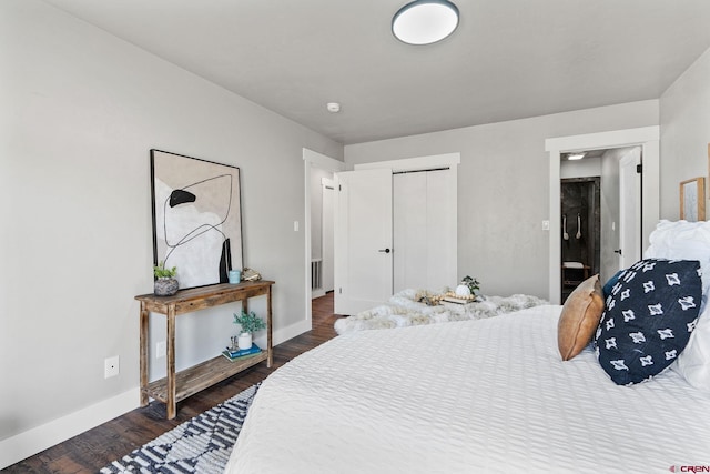 bedroom with a closet and dark hardwood / wood-style flooring