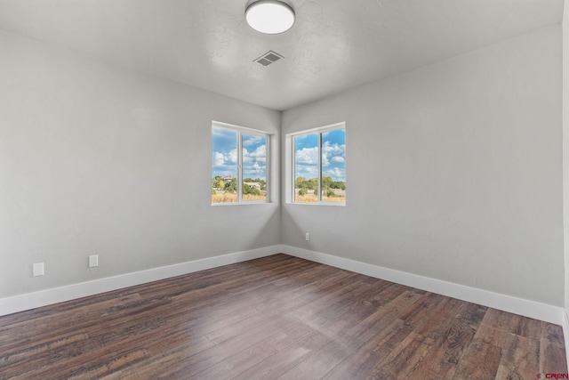 spare room featuring dark hardwood / wood-style floors