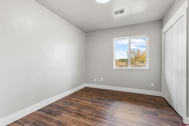 spare room featuring dark hardwood / wood-style floors