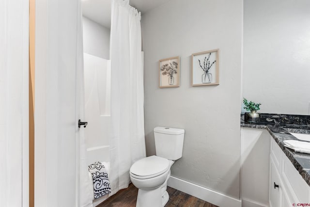 bathroom featuring vanity, toilet, and hardwood / wood-style flooring