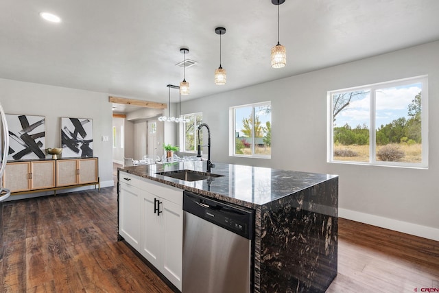 kitchen with stainless steel dishwasher, sink, a kitchen island with sink, and decorative light fixtures