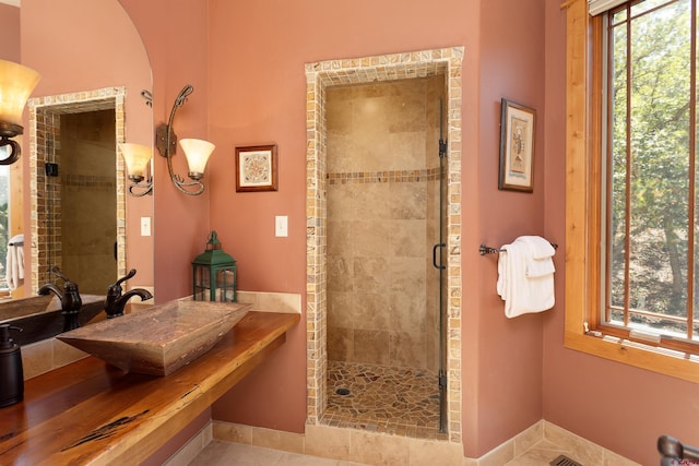 2239 Mockingbird Valley Ct, Durango, CO 81301 - bathroom with a stall shower, tile patterned flooring, and a sink