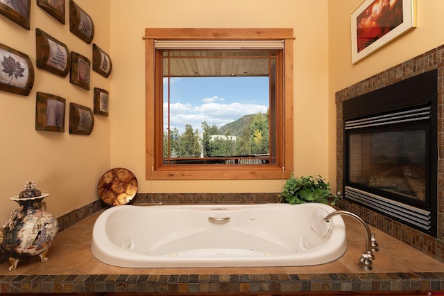 2239 Mockingbird Valley Ct, Durango, CO 81301 - full bathroom with a whirlpool tub and a glass covered fireplace