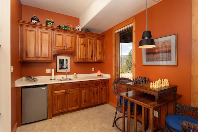 2239 Mockingbird Valley Ct, Durango, CO 81301 - kitchen with fridge, a sink, brown cabinetry, light countertops, and light carpet