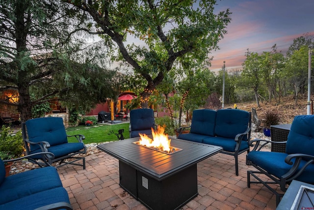 2239 Mockingbird Valley Ct, Durango, CO 81301 - patio terrace at dusk with an outdoor living space with a fire pit and a patio area