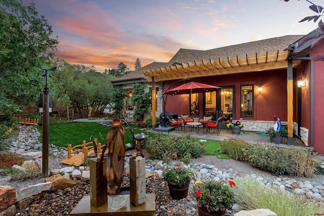2239 Mockingbird Valley Ct, Durango, CO 81301 - yard at dusk with a pergola, a patio, a yard, and an outdoor living space