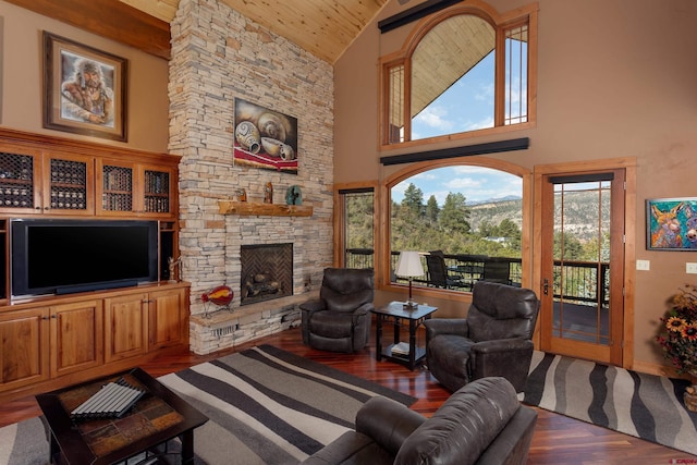 2239 Mockingbird Valley Ct, Durango, CO 81301 - living room with wood ceiling, high vaulted ceiling, wood finished floors, a stone fireplace, and baseboards