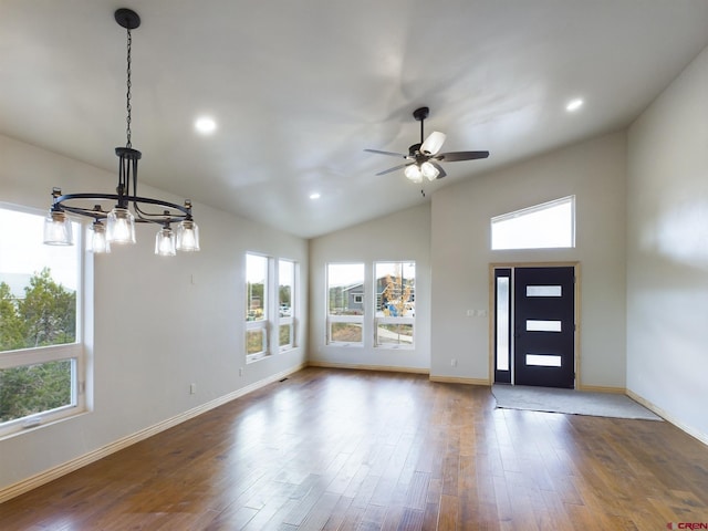 foyer with lofted ceiling, ceiling fan with notable chandelier, and hardwood / wood-style floors