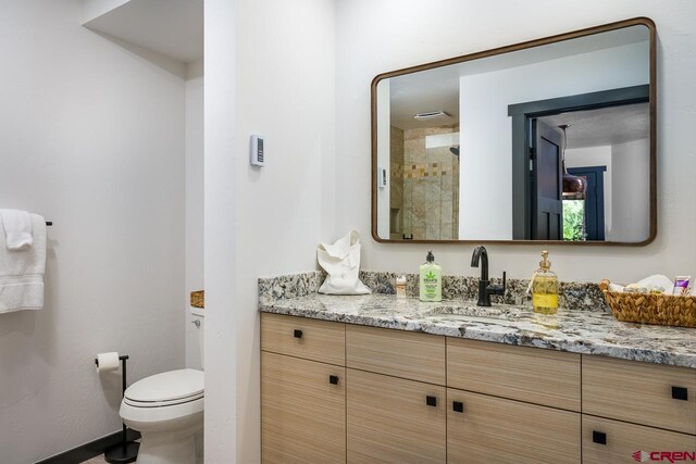 bathroom with vanity, toilet, and an enclosed shower