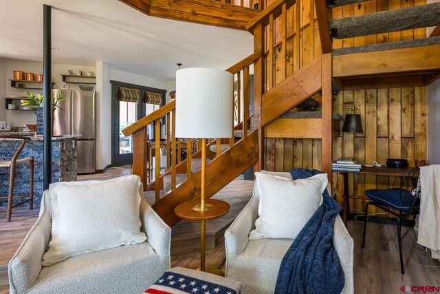 living room with wooden walls and wood-type flooring