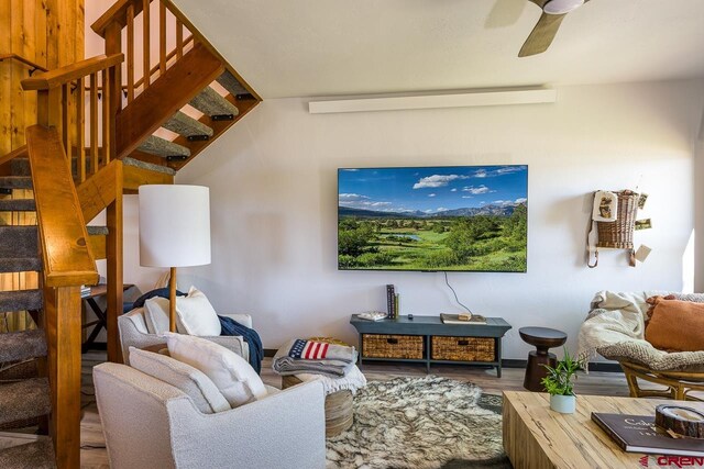 living room with ceiling fan and hardwood / wood-style flooring