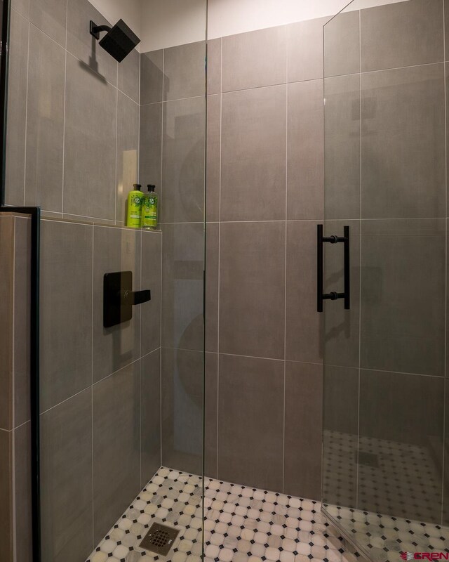 bathroom featuring a shower with door