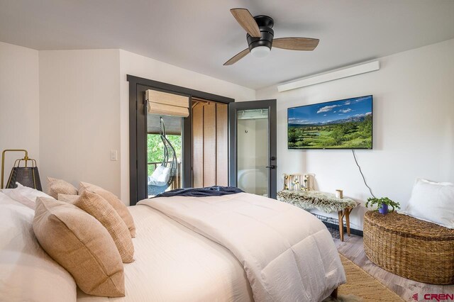 bedroom featuring access to outside, hardwood / wood-style flooring, and ceiling fan