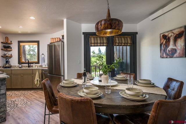 dining room with light hardwood / wood-style floors and sink