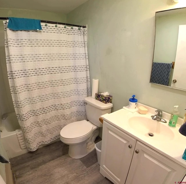 full bathroom with toilet, vanity, wood-type flooring, and shower / tub combo