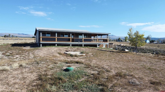 view of front of house featuring a mountain view and a rural view