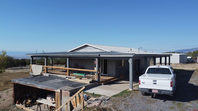 rear view of house featuring a carport