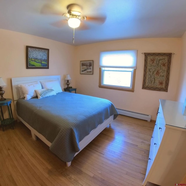 bedroom with a baseboard radiator, light hardwood / wood-style flooring, and ceiling fan