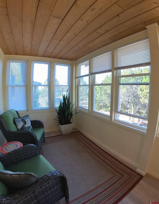 sunroom / solarium featuring wood ceiling and vaulted ceiling