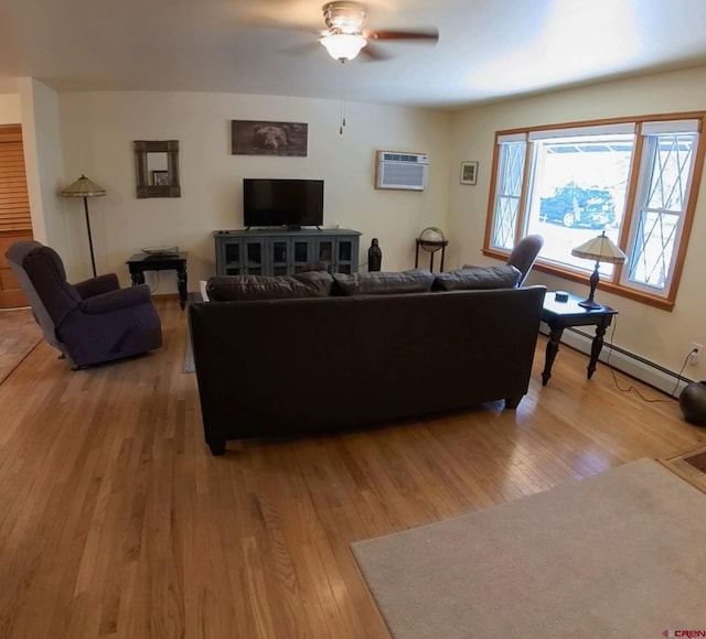 living room with a wall mounted AC, a baseboard heating unit, hardwood / wood-style flooring, and ceiling fan