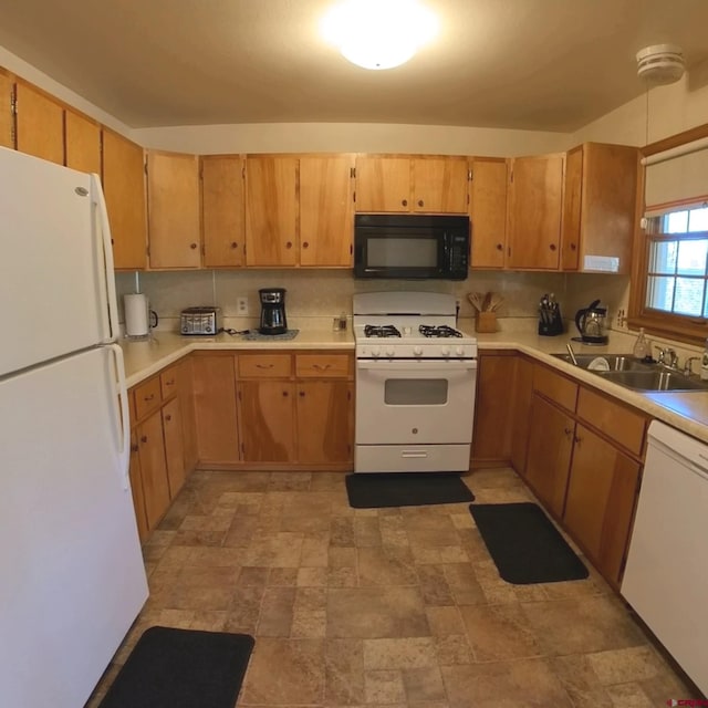 kitchen featuring white appliances, tasteful backsplash, and sink