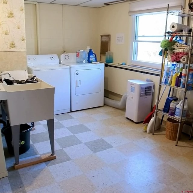 laundry room featuring sink and washer and clothes dryer