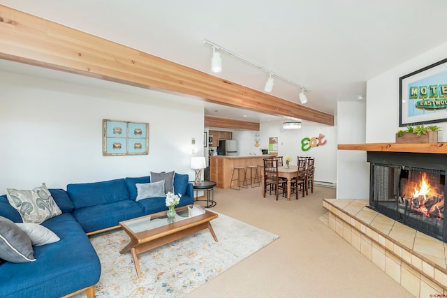 carpeted living room featuring track lighting and a fireplace