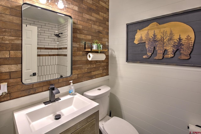 bathroom featuring vanity, a shower, and toilet