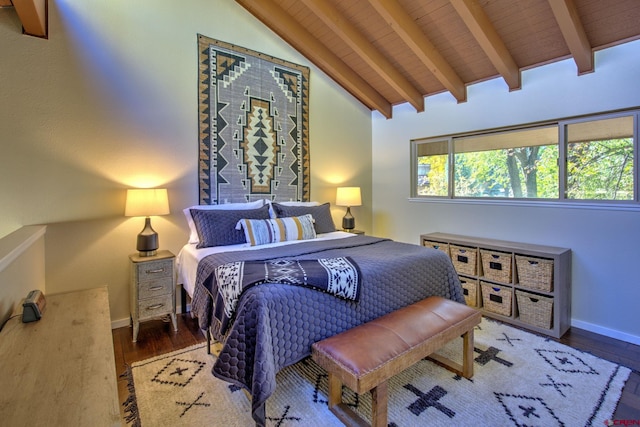 bedroom featuring vaulted ceiling with beams, multiple windows, and hardwood / wood-style flooring