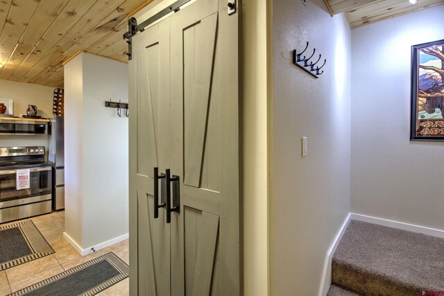33 Davis Cup Unit 4008, Pagosa Springs, CO 81147 - hallway featuring wood ceiling, a barn door, baseboards, and light tile patterned flooring