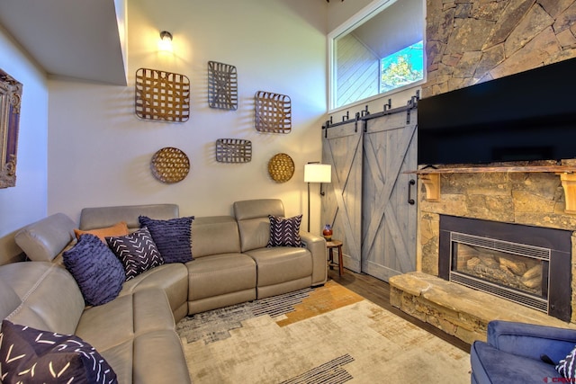 33 Davis Cup Unit 4008, Pagosa Springs, CO 81147 - living room with a fireplace, wood finished floors, and a barn door